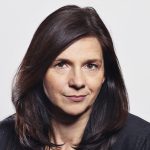 Katrin Göring-Eckardt Porträt von Katrin Göring-Eckardt mit langen, dunklen Haaren und neutralem Hintergrund.